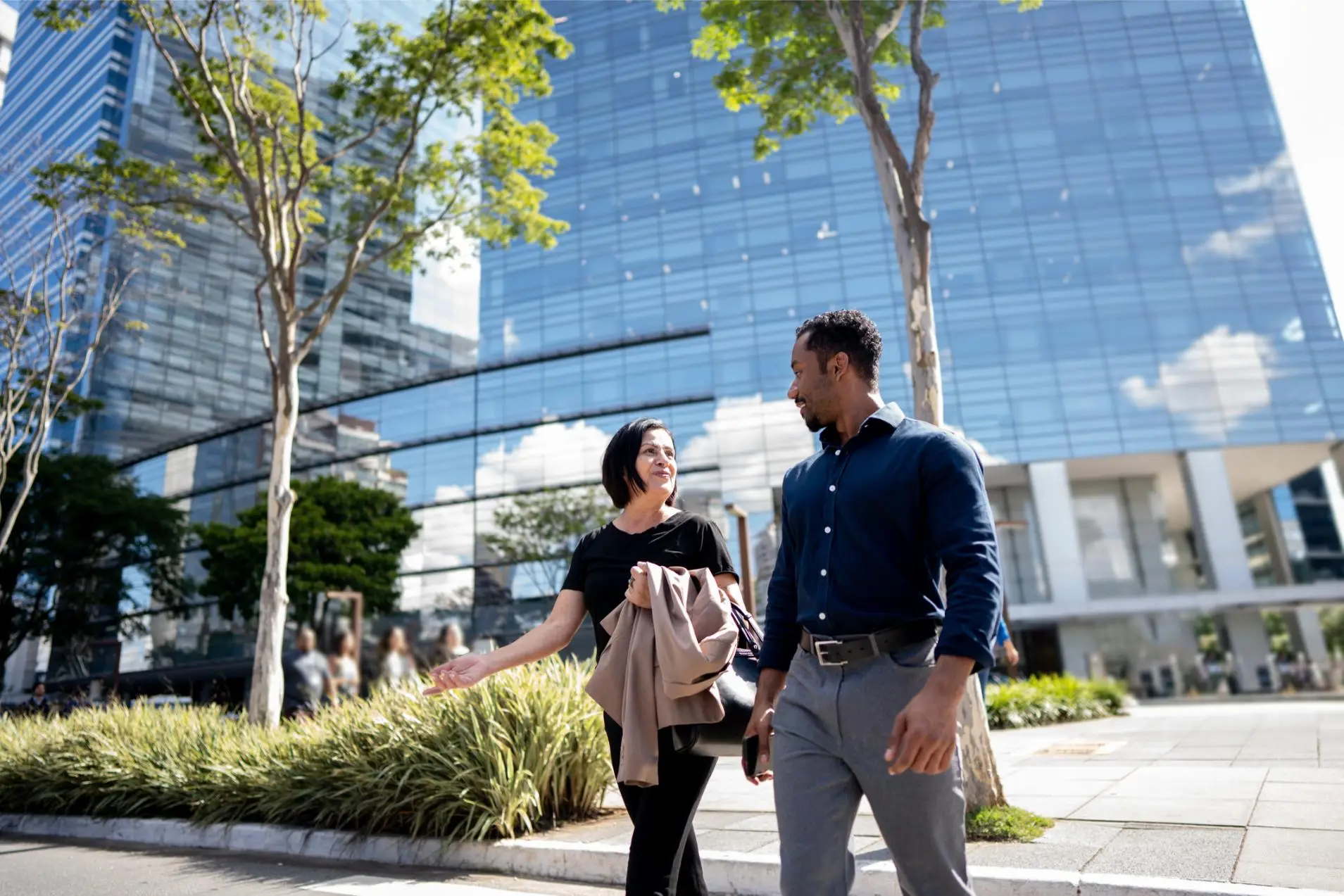 Coworkers talking while walking in the street